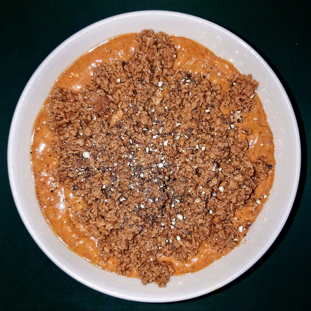 A bowl of chili topped with textured vegetable protein.