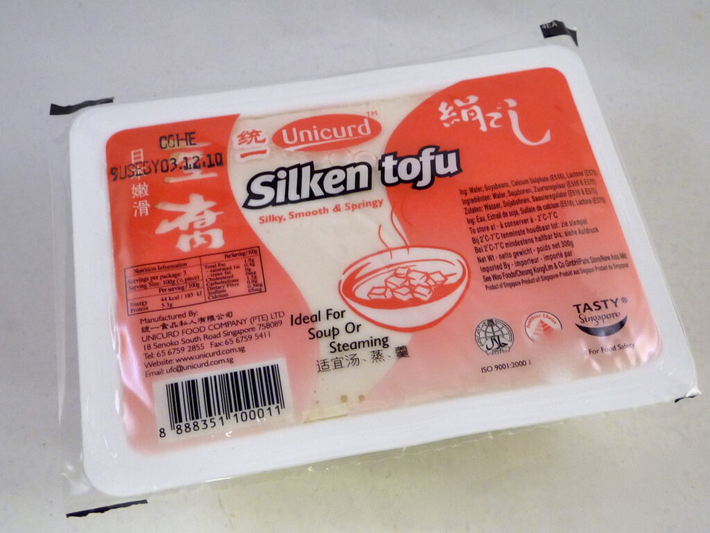 A sealed package of Unicurd silken tofu.