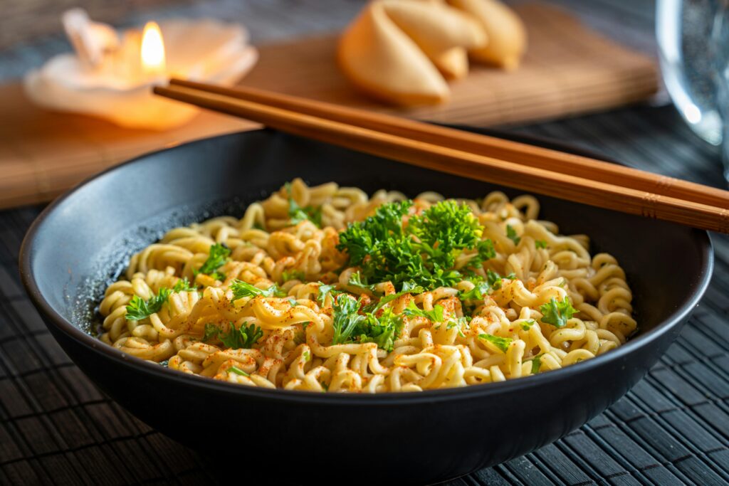 A bowl of noodles topped with parsley.